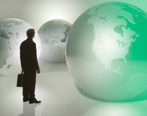 Businessman standing among globes